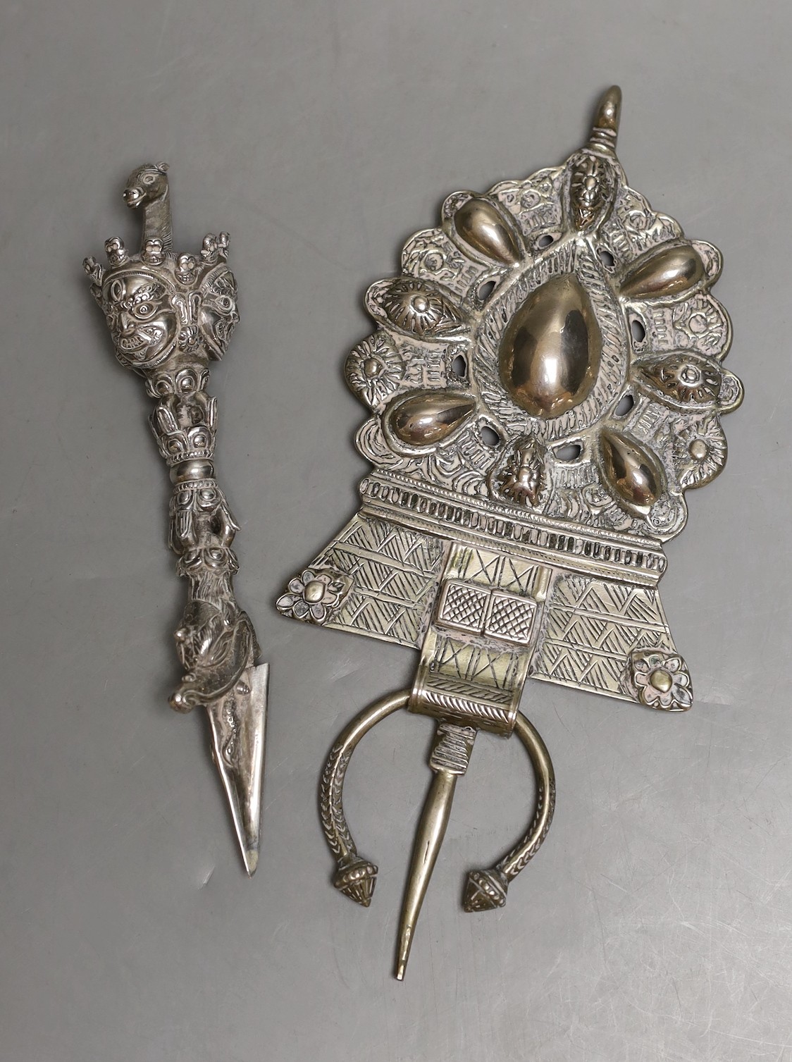 A Tibetan metal phurba and a South Asian metal finial, finial 22cms high.